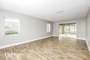 Rockledge house for rent - the living room and dining room with wood flooring and sliding glass doors