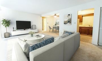 Clarendon Hills apartment for rent - A living room with a grey sofa and a television.