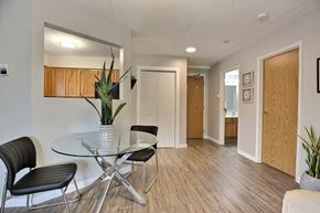 Regina apartment for rent - a dining room with a glass table and chairs