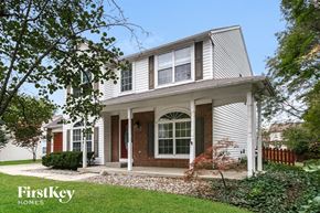 Carmel house for rent - a white house with red doors and a lawn