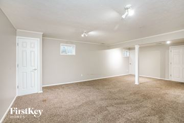 Carmel house for rent - a spacious living room with carpet and white doors