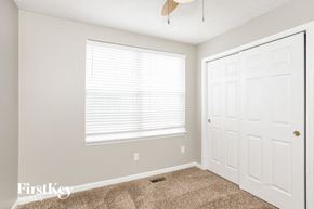 Carmel house for rent - a bedroom with a white door and a window and a carpeted floor