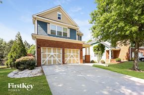 Newnan house for rent - A house with a garage and a driveway in front of it.