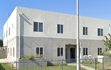 Los Angeles apartment for rent - a large white building with a fence in front of it