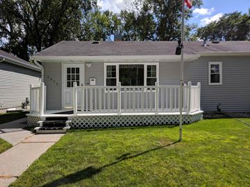 Grand Forks house for rent - A house with a grey roof and a white porch.