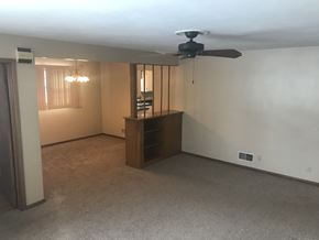 Grand Forks house for rent - A room with a ceiling fan and a cabinet.