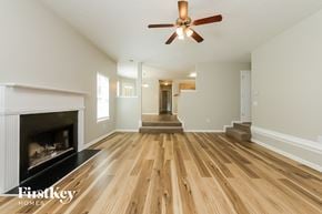 Mcdonough house for rent - a living room with a fireplace and a ceiling fan