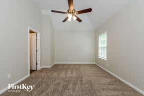 Mcdonough house for rent - the master bedroom has a carpeted floor and a ceiling fan