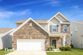 Whitestown house for rent - a house with a white garage door in front of it
