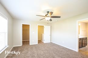 Whitestown house for rent - a living room with a ceiling fan and a closet