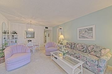 Bradenton house for rent - a living room with a couch and chairs and a table