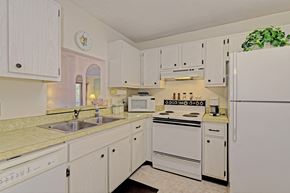 Bradenton house for rent - a kitchen with white appliances and white cabinets