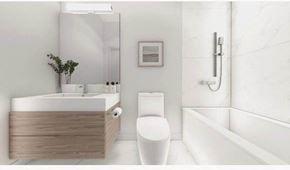 Montréal apartment for rent - A white toilet sits next to a bathtub in a bathroom.