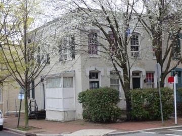 Washington apartment for rent - A white building with a tree in front of it.