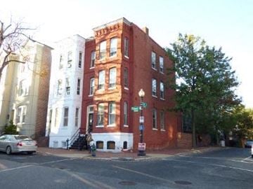 Washington apartment for rent - A red brick building is in the middle of a street.