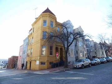 Washington apartment for rent - A yellow building with a red stop sign in front of it.