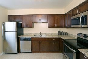 Glendale Heights apartment for rent - a kitchen with stainless steel appliances and wooden cabinets