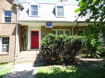 Washington apartment for rent - A house with a red door and a sign that says "For Sale".