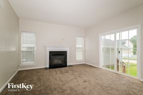O'fallon house for rent - A living room with a fireplace and sliding glass doors.
