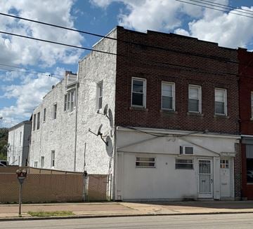 Glassport apartment for rent - a white and red brick building on the corner of a street
