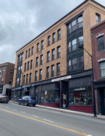 Brattleboro apartment for rent - A street view of a building with a sign that reads "Estate Uses & Hire".