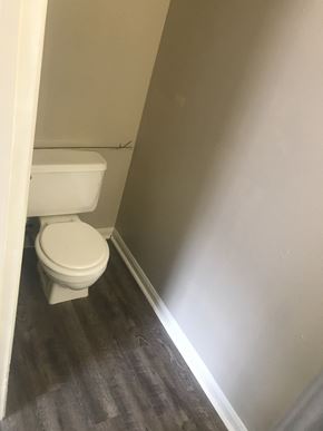 Lafayette apartment for rent - a small bathroom with a toilet and wood flooring