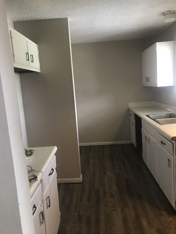 Lafayette apartment for rent - an empty kitchen with white cabinets and a sink
