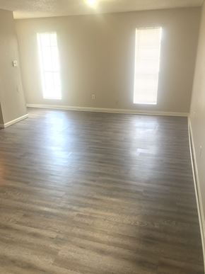 Lafayette apartment for rent - an empty living room with wood floors and white walls