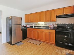 Winter Park apartment for rent - A kitchen with wooden cabinets and a stainless steel refrigerator.