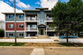 Brandon apartment for rent - a blue apartment building with a tree in front of it