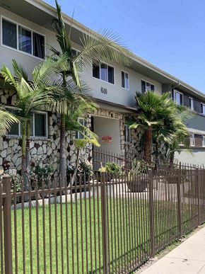 Los Angeles apartment for rent - a house with a fence and palm trees in front of it