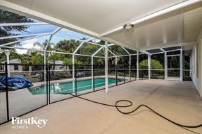 North Port house for rent - a large patio with a pool in a house with glass doors