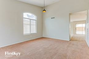 San Tan Valley house for rent - A spacious room with a carpeted floor and a window with blinds.