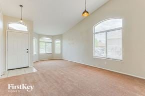San Tan Valley house for rent - A room with a carpeted floor and a door on the left side.