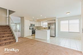 San Tan Valley house for rent - A spacious kitchen and living room with a staircase on the left side.