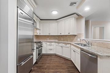 Park Ridge apartment for rent - a kitchen with white cabinets and stainless steel appliances