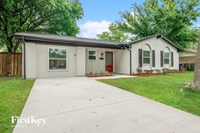 Garland house for rent - A white house with a red door is for sale.