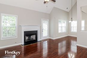 Clarkston house for rent - a living room with a fireplace and a wooden floor