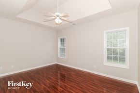 Clarkston house for rent - a bedroom with hardwood flooring and a ceiling fan