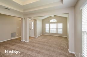 Jacksonville house for rent - A spacious room with a carpeted floor and a doorway leading to another room.