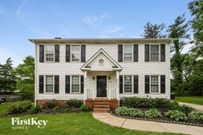 Greensboro house for rent - a white house with black window shutters and a sidewalk