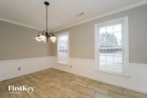 Greensboro house for rent - an empty dining room with two windows and a tiled floor