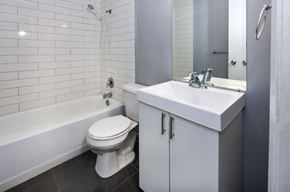 Waterloo apartment for rent - A white toilet sits next to a white sink in a bathroom.