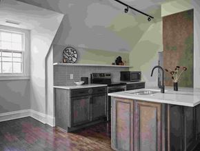 Cleveland Heights apartment for rent - A kitchen with a black oven and a white counter.