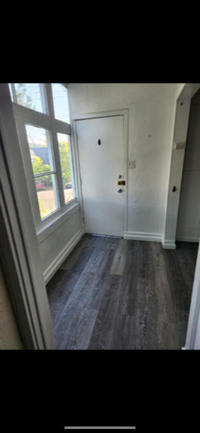 Los Angeles apartment for rent - A white door is in a room with a wooden floor.