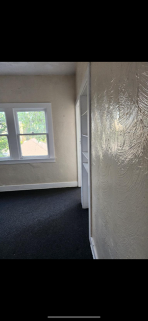 Los Angeles apartment for rent - A room with a window and a carpeted floor.