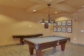 Billings apartment for rent - A pool table in a room with a chandelier and pictures on the wall.
