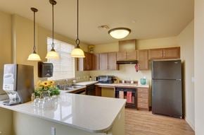 Billings apartment for rent - A kitchen with a white counter top and a black refrigerator.