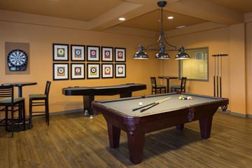 Bellingham apartment for rent - A pool table with a dart board on the wall.