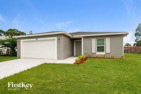 Palm Bay house for rent - A house with a garage and a driveway in front of it.